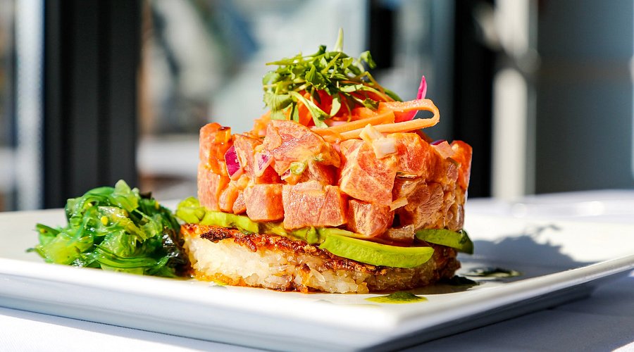 The Reef signature dishes Spicy Tuna Crispy Rice, Chilled Lobster Roll, House Oysters, Shrimp Scampi